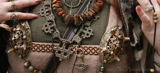 A close-up of a modern-day Viking wearing a layered set of Bronze Viking jewelry necklaces 