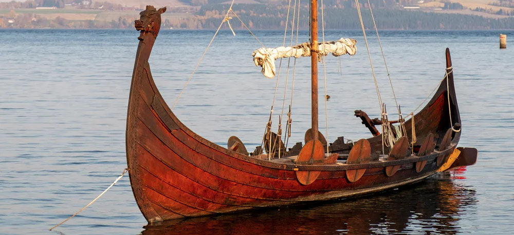 A Viking boat in the water. Vikings wearing the helm of awe necklace would be inspired and empowered during sea-faring battles. 