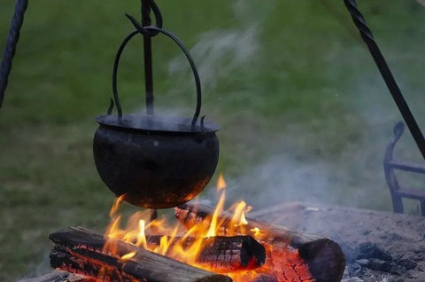 Viking cooking in an iron cauldron over an open fire