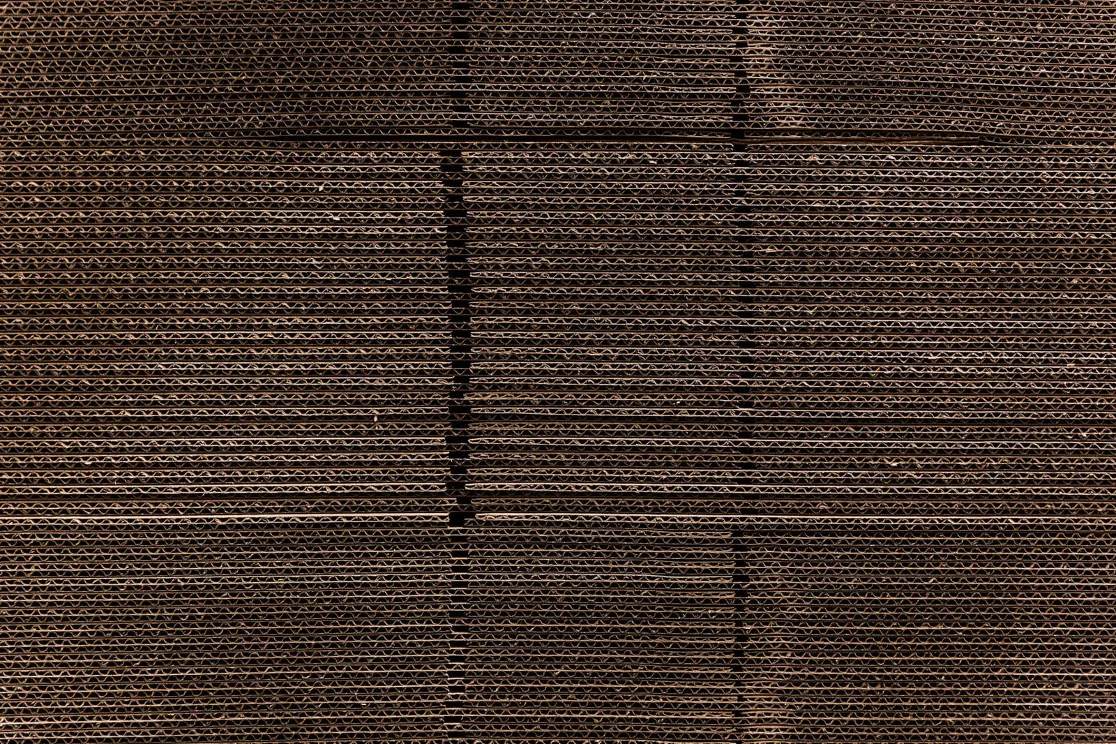 Brown corrugated cardboard with visible ridged texture and seams.