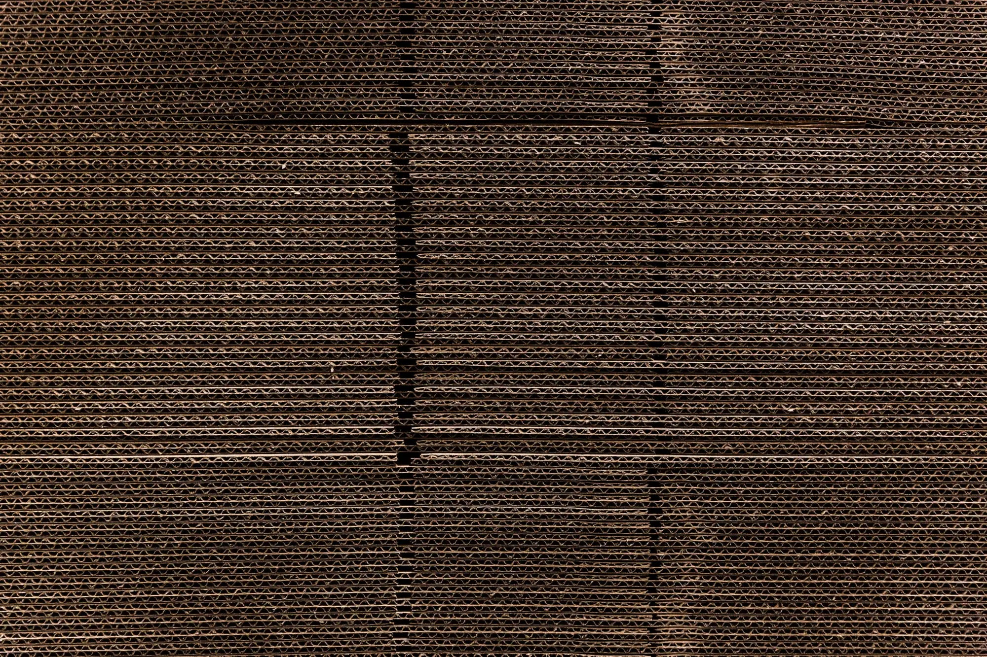 Brown corrugated cardboard with visible ridged texture and seams.